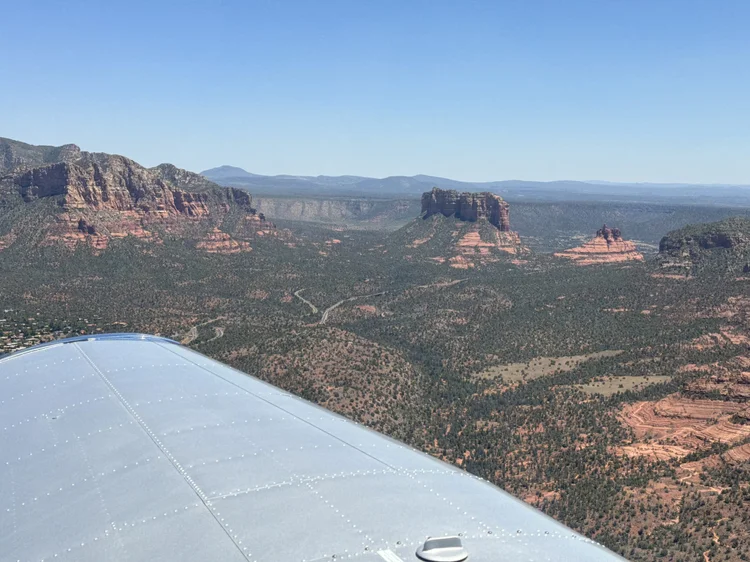 View from a Cessna wing over the red rock formations near Sedona, Arizona