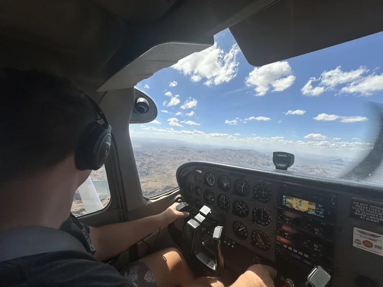 An SG Flight School student flying a Cessna 172 over the Arizona desert